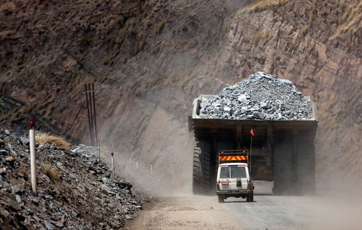 A safety vehicle follows a mining truck loaded with excavated kimberlite rock out of Jwaneng mine, operated by the Debswana Diamond Co., a joint venture between De Beers and Botswana's government, in Jwaneng, Botswana, on Wednesday, Oct. 24, 2012. XXX SECOND SENTENCE HERE XXX. Photographer: Chris Ratcliffe/Bloomberg